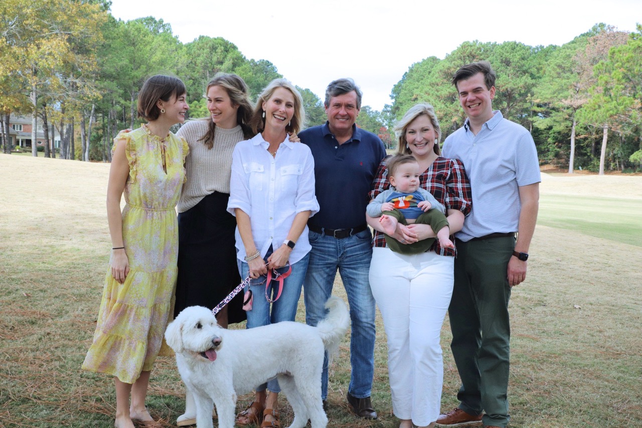 Melissa Snowden with her husband Frank, their daughters, a son-in-law, a grandson, and family dog Muffy